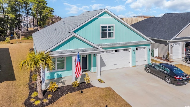 view of front of property featuring a front lawn and a garage