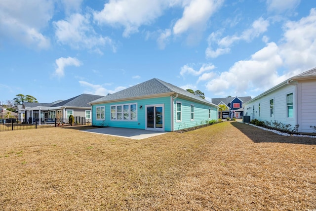 rear view of property with a patio and a lawn