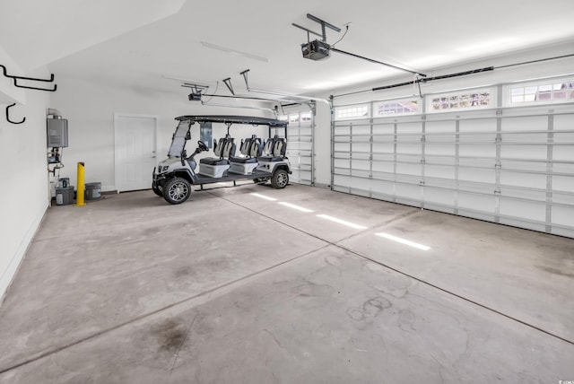 garage featuring water heater and a garage door opener