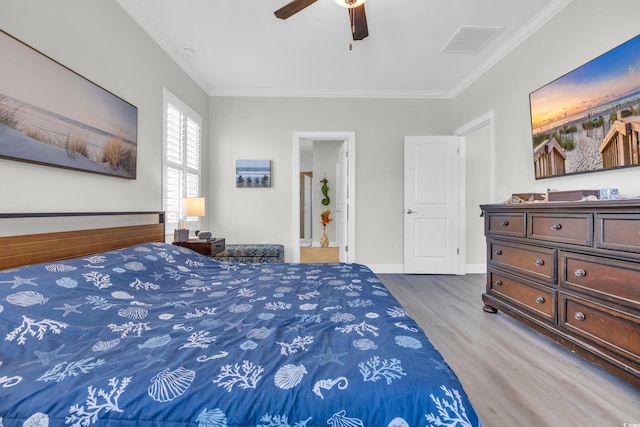 bedroom featuring ceiling fan, crown molding, and wood-type flooring