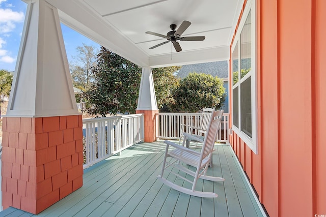 deck with ceiling fan and covered porch