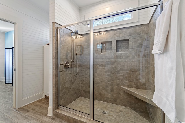 bathroom with an enclosed shower and hardwood / wood-style floors