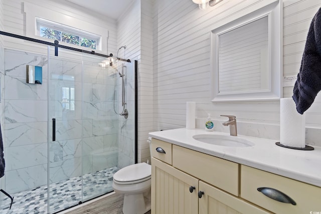 bathroom featuring an enclosed shower, vanity, and toilet