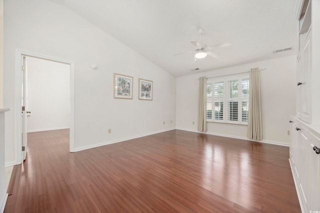 spare room with ceiling fan, dark hardwood / wood-style flooring, and vaulted ceiling