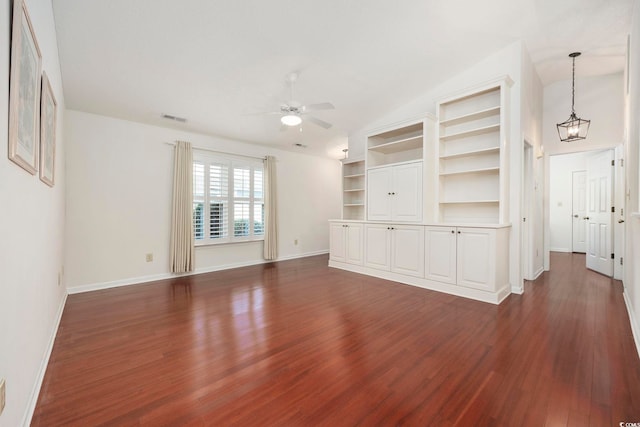 unfurnished living room featuring dark wood-type flooring and ceiling fan