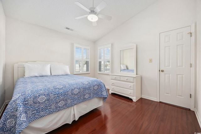 bedroom with dark hardwood / wood-style flooring, a textured ceiling, vaulted ceiling, and ceiling fan