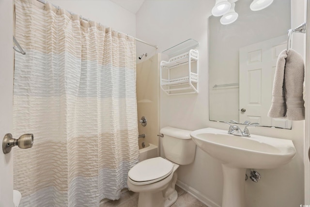 bathroom with shower / tub combo with curtain, tile patterned floors, and toilet