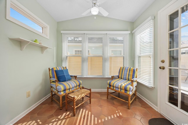 living area with tile patterned flooring, a wealth of natural light, and vaulted ceiling