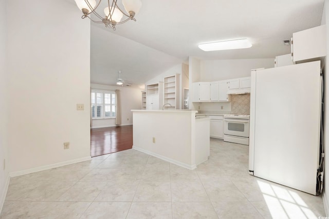 kitchen with lofted ceiling, white appliances, white cabinets, light tile patterned flooring, and decorative light fixtures