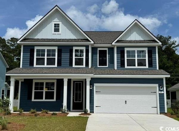 551 Slaty Dr, Myrtle Beach, SC 29588 - view of front of home with board and batten siding, concrete driveway, a garage, and covered porch