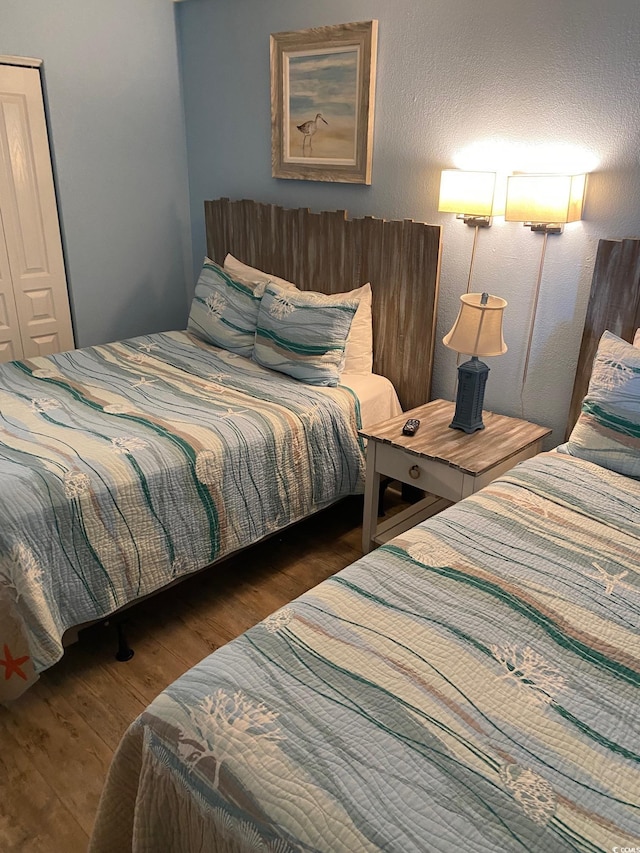 bedroom with dark hardwood / wood-style flooring