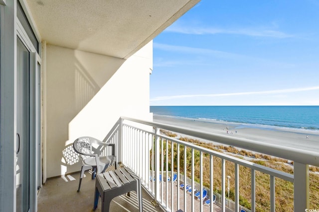 balcony with a beach view and a water view