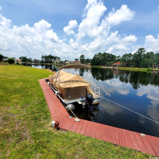 dock area featuring a lawn and a water view