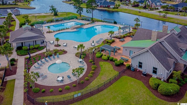 view of pool featuring a water view and a patio