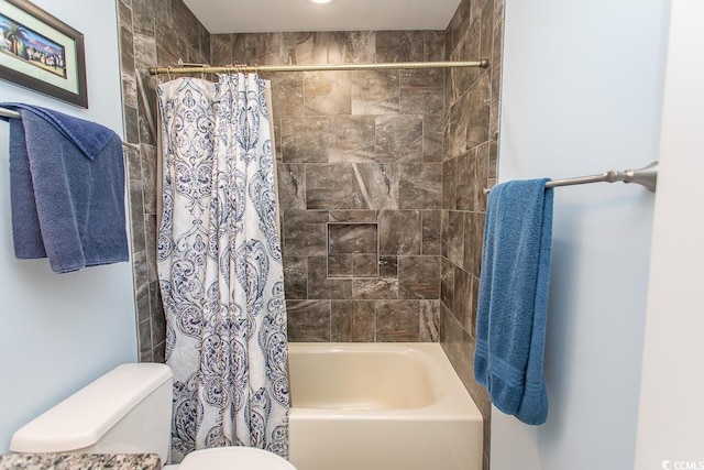 bathroom with shower / bath combo with shower curtain and toilet