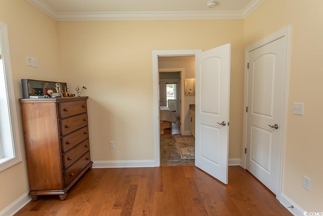 bedroom with hardwood / wood-style flooring and crown molding