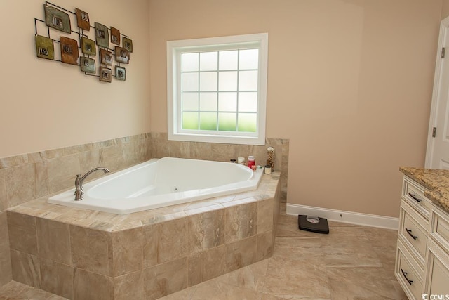 bathroom featuring tiled tub and vanity