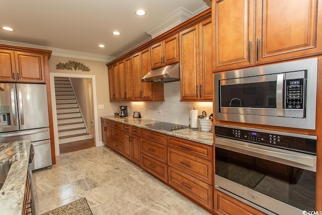 kitchen featuring light stone counters, backsplash, ornamental molding, and stainless steel appliances