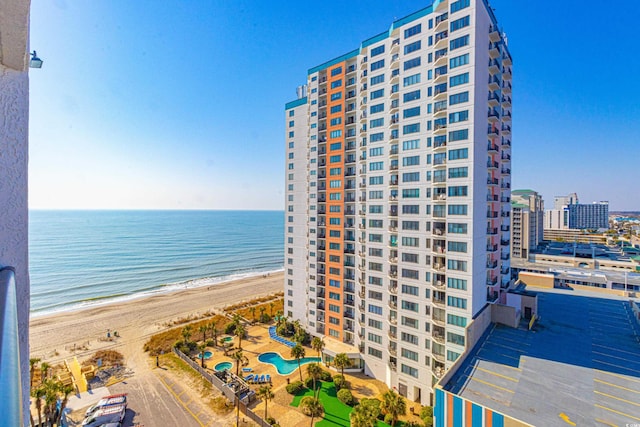 view of property with a beach view and a water view