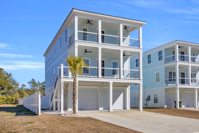 raised beach house with ceiling fan, a garage, and a balcony