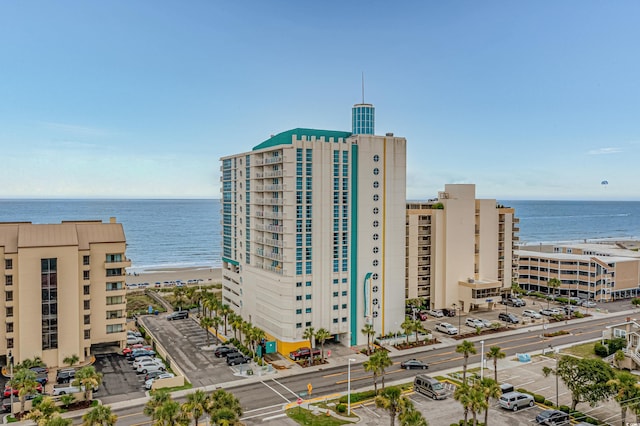 view of property featuring a water view and a beach view