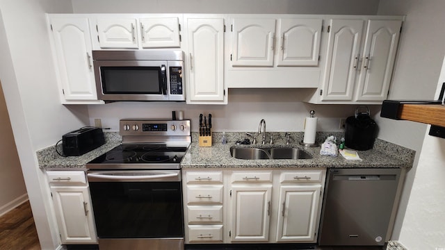 kitchen featuring white cabinetry, sink, and appliances with stainless steel finishes