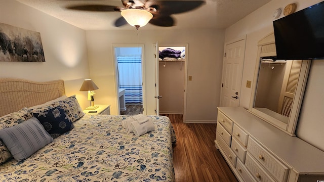 bedroom with dark wood-type flooring, a textured ceiling, and ceiling fan