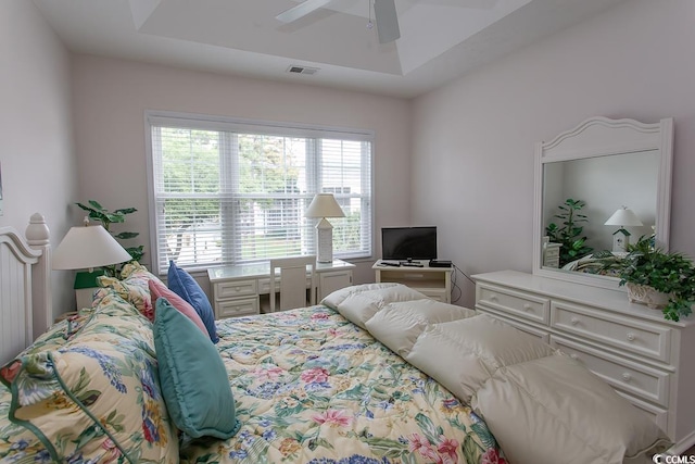 bedroom featuring ceiling fan and a tray ceiling