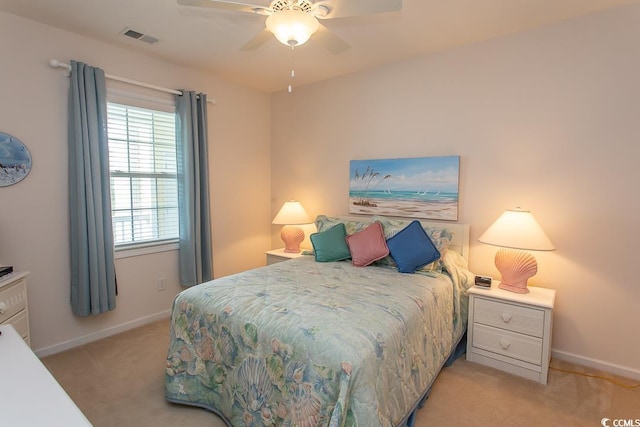 bedroom with light carpet and ceiling fan