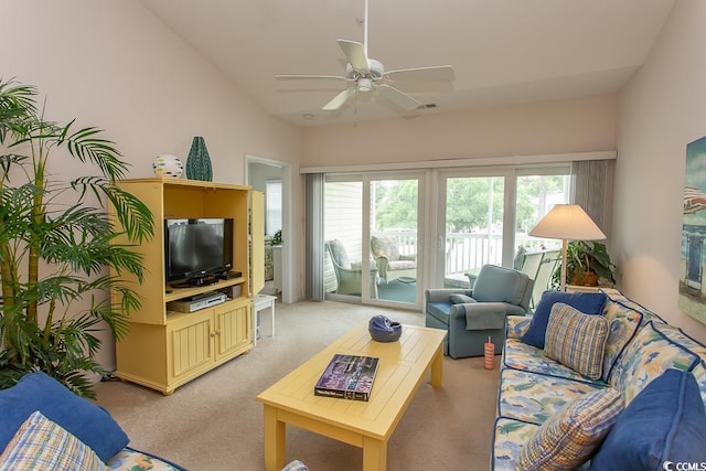 living room with ceiling fan, vaulted ceiling, light carpet, and a wealth of natural light