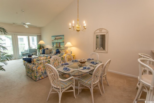 carpeted dining area with ceiling fan with notable chandelier and high vaulted ceiling