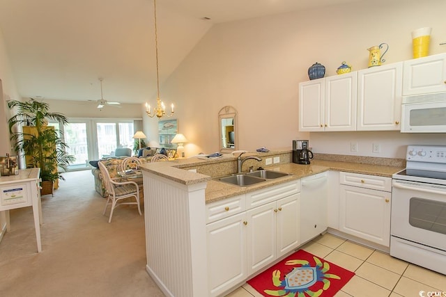 kitchen featuring sink, white appliances, hanging light fixtures, white cabinets, and kitchen peninsula