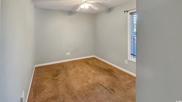 carpeted empty room featuring ceiling fan and a textured ceiling