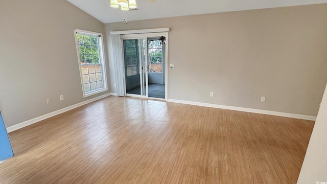 unfurnished room with ceiling fan, lofted ceiling, and light hardwood / wood-style floors