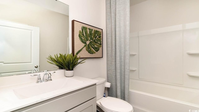 full bathroom featuring vanity, shower / bath combination with curtain, and toilet