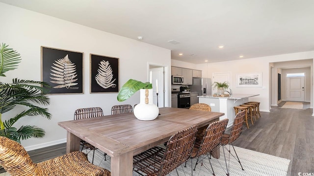 dining area featuring dark wood-type flooring