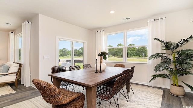 dining space with hardwood / wood-style floors