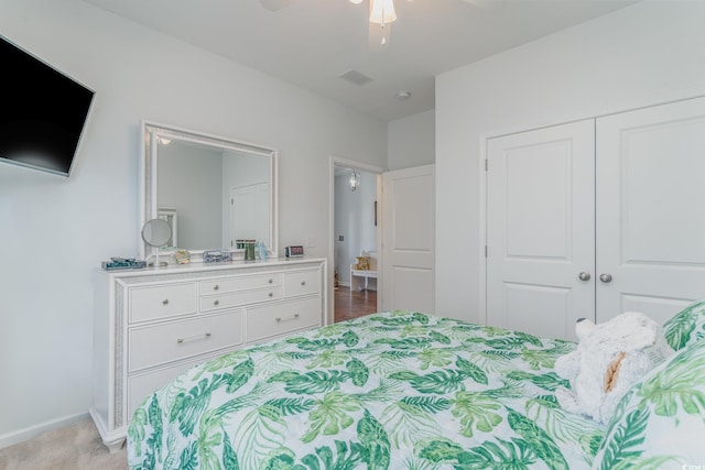 carpeted bedroom with a closet and ceiling fan