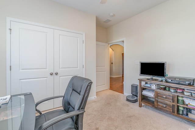 home office with light carpet and ceiling fan