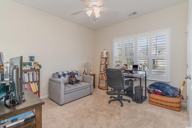 carpeted office space featuring ceiling fan