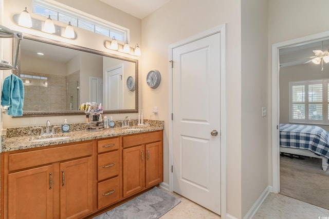 bathroom with ceiling fan, vanity, and a tile shower