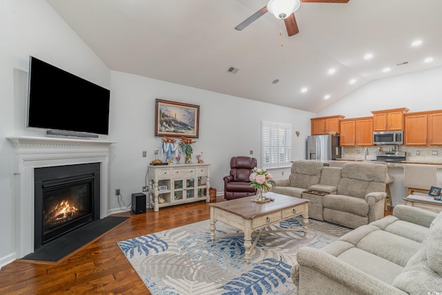 living room with ceiling fan, dark hardwood / wood-style flooring, and high vaulted ceiling