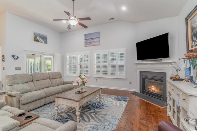 living room featuring ceiling fan, lofted ceiling, and dark hardwood / wood-style flooring