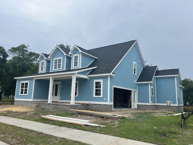 1004 James Island Ave, North Myrtle Beach, SC 29582 - view of front of house with covered porch, an attached garage, and a front lawn