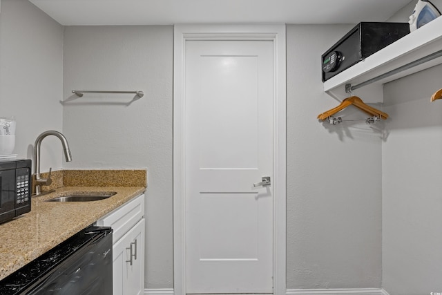 7200 N Ocean Blvd Unit 138, Myrtle Beach, SC 29572 - kitchen with white cabinetry, black microwave, a sink, dishwashing machine, and light stone counters