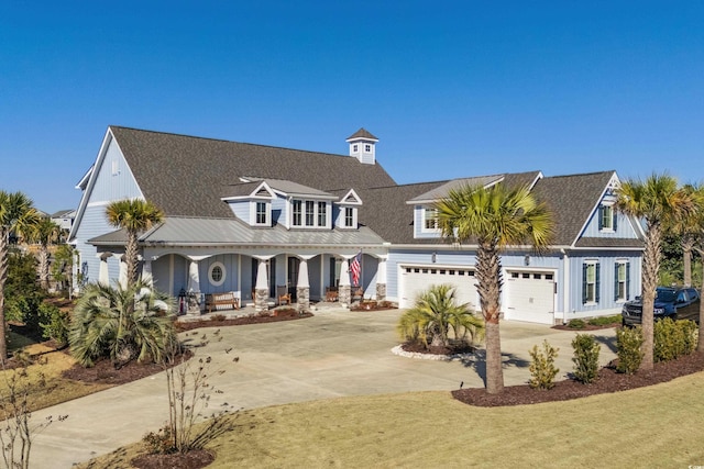 view of front facade with a garage, a front yard, and covered porch