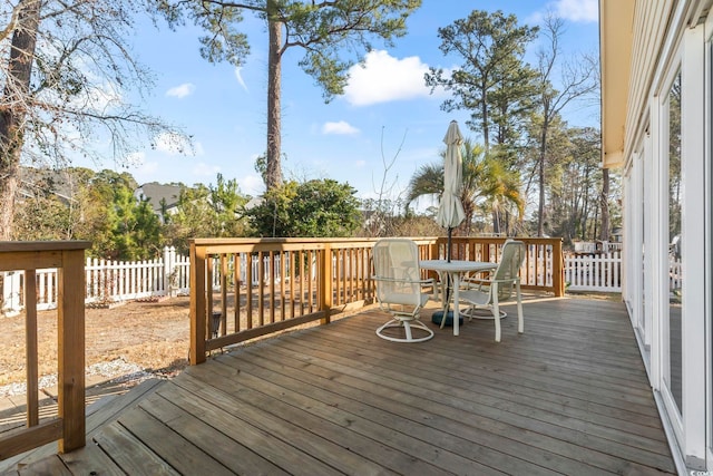 wooden deck with outdoor dining space and fence