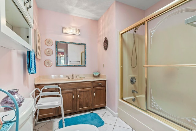 full bath with bath / shower combo with glass door, vanity, and tile patterned floors