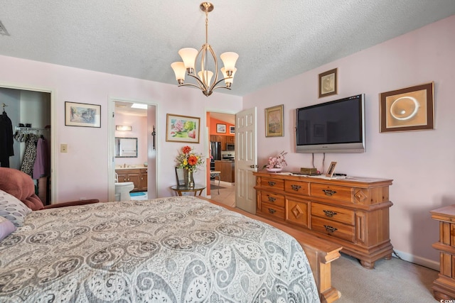 bedroom featuring a textured ceiling, ensuite bathroom, baseboards, carpet, and an inviting chandelier