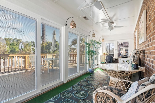 sunroom featuring a ceiling fan and visible vents